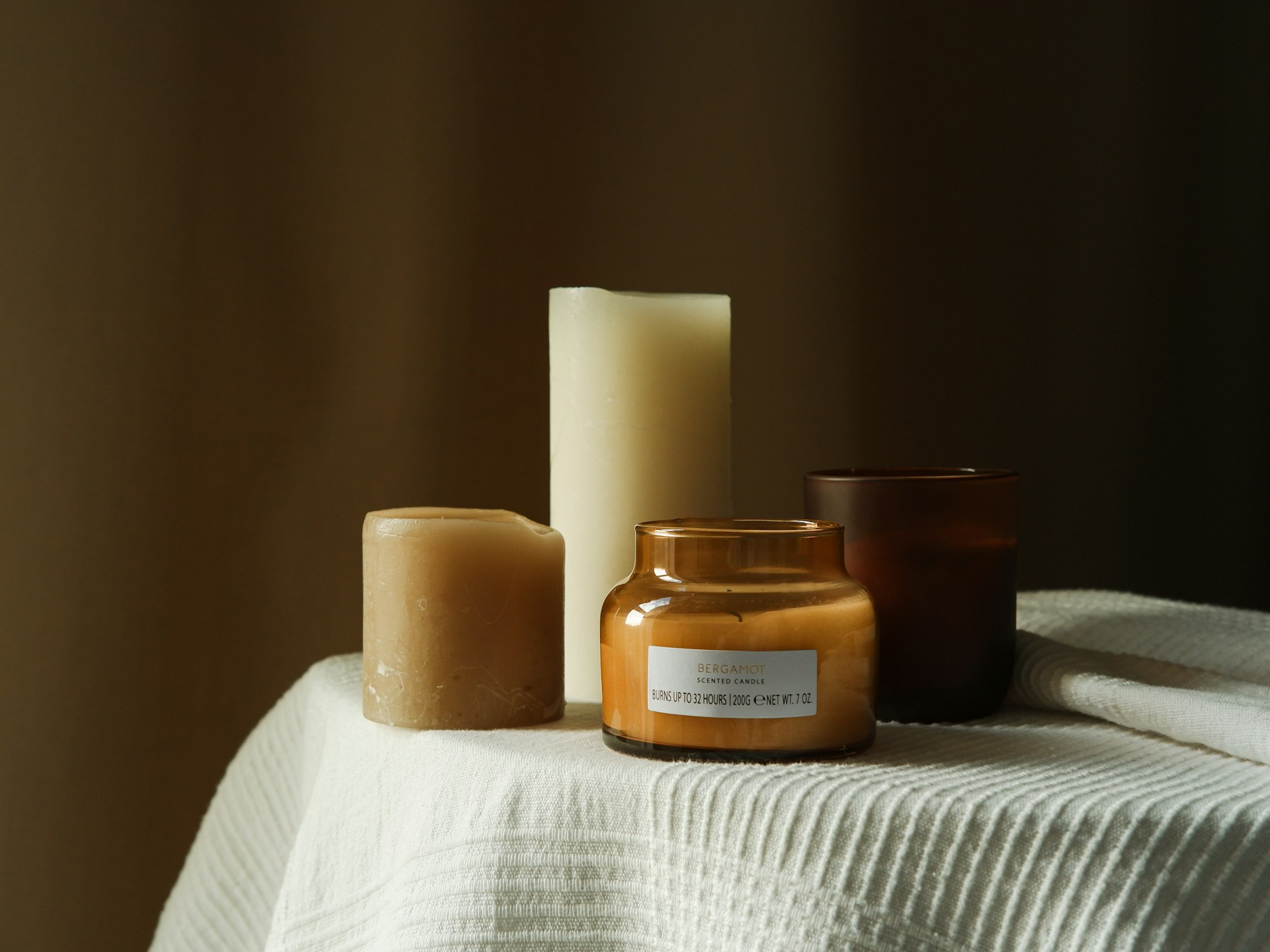 Warm candles on linen, soft light